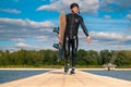 Confident wakeboarder walking with board along pier after training Royalty Free Stock Photo