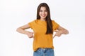 Confident, sassy gorgeous caucasian brunette woman in yellow t-shirt, advice check out cool link and take part event