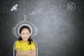 Confident schoolgirl imagining being an astronaut