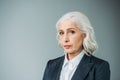 Confident senior businesswoman in suit on grey Royalty Free Stock Photo