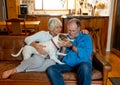 Couple relaxing at home and loving their pet. Positive image of life at home and New Normal Royalty Free Stock Photo