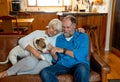 Couple relaxing at home and loving their pet. Positive image of life at home and New Normal Royalty Free Stock Photo