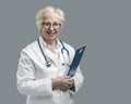 Confident senior female doctor posing and smiling Royalty Free Stock Photo