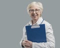 Confident senior female doctor posing and smiling Royalty Free Stock Photo