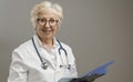 Confident senior female doctor posing and smiling Royalty Free Stock Photo