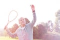 Confident senior man serving badminton in park Royalty Free Stock Photo