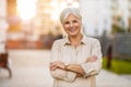 Confident senior woman in the city at sunset Royalty Free Stock Photo