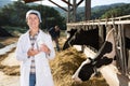 Senior woman veterinarian with milk on dairy farm Royalty Free Stock Photo