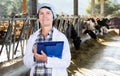 veterinarian with clipboard working on cow farm Royalty Free Stock Photo