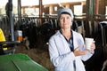 Senior woman veterinarian with milk on dairy farm Royalty Free Stock Photo