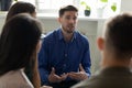 Confident serious male coach mentor talking holding briefing for team. Royalty Free Stock Photo