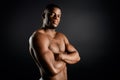 Confident serious personal trainer with folded arms posing to the camera