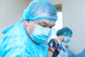 Confident serious surgeon in surgical room hospital, medical doctor wear surgery suit during surgery