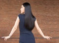 Confident and Smart Asian woman turning around with red brick wall interior. Royalty Free Stock Photo