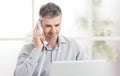 Confident smiling businessman and consultant working in his office, he is having a phone call: communication and business concept Royalty Free Stock Photo