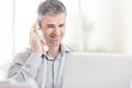 Confident smiling businessman and consultant working in his office, he is having a phone call Royalty Free Stock Photo