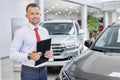 Confident smiling car dealer at work Royalty Free Stock Photo