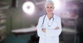 Confident smiling caucasian mature female doctor with arms crossed standing in operation theater Royalty Free Stock Photo