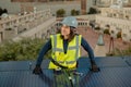 Female electrician engineer portrait by photovoltaic Solar Panels city rooftop Royalty Free Stock Photo