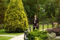 Confident smiling handsome groom in suit walking in the park Royalty Free Stock Photo