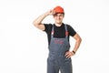 Confident and smiling manual worker with helmet posing isolated on white background Royalty Free Stock Photo