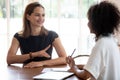 Confident woman job applicant answering hr manager questions during interview