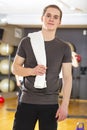 Confident and smiling young man exercising at fitness gym Royalty Free Stock Photo