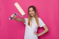 Confident Smiling Young Woman Is Holding Paint Roller