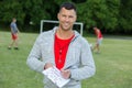 Confident soccer coach posing for photography