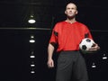 Confident Soccer Player Holding Ball