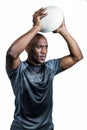 Confident sportsman throwing rugby ball