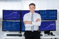 Confident Stock Market Broker Leaning On Desk Royalty Free Stock Photo