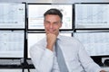 Confident Stock Market Broker Leaning On Desk Royalty Free Stock Photo