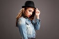Confident, streetwear and girl in studio, Gen z and fashion for portrait, mock up and clothes to relax. Brown background