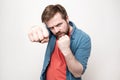 Confident, strong man clenched big fists, looked fearlessly and was about to defend himself, on a white background Royalty Free Stock Photo