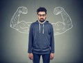 Confident strong man hipster on wall background