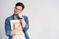 Confident student. Studio portrait of handsome young man holding books. Isolated on white. Royalty Free Stock Photo