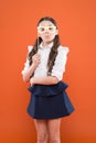 Confident student studying. school girl in uniform. child with party glasses. smart and intelligent kid on orange Royalty Free Stock Photo