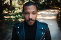 Confident stylish african american man wearing black leather jacket outdoor. Street wear fashion black man Royalty Free Stock Photo