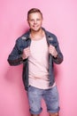 Confident stylish casual guy posing on pink