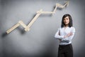 Confident successful businesswoman in front of positive trend chart. Royalty Free Stock Photo