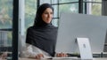 Confident successful elegant arab businesswoman typing on computer attractive muslim female in hijab professional worker Royalty Free Stock Photo