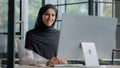 Confident successful elegant arab businesswoman typing on computer attractive muslim female in hijab professional worker Royalty Free Stock Photo