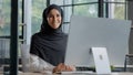 Confident successful elegant arab businesswoman typing on computer attractive muslim female in hijab professional worker Royalty Free Stock Photo