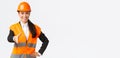 Confident successful female architect, leader of construction in safety helmet, reflective jacket, extand hand for