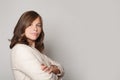 Confident successful woman ready for work standing with crossed arms against grey studio wall background, business concept Royalty Free Stock Photo