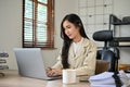 Confident Asian businesswoman concentrating on her work on laptop computer Royalty Free Stock Photo