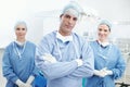 Confident surgeons. Portrait of two female nurses and a male doctor wearing hosptial scrubs in an operating room. Royalty Free Stock Photo