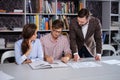 Confident team of engineers working together in a architect studio.