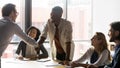 Confident team leader shaking hands with smiling african american employee. Royalty Free Stock Photo